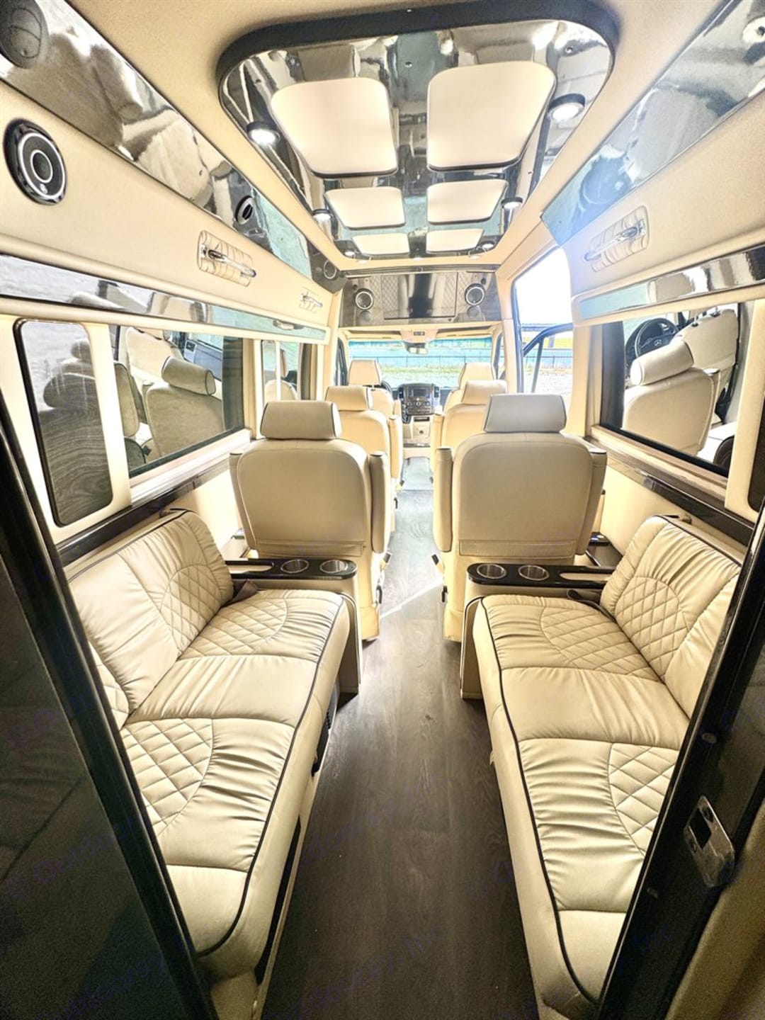 Cruising van interior with cream seating and center aisle