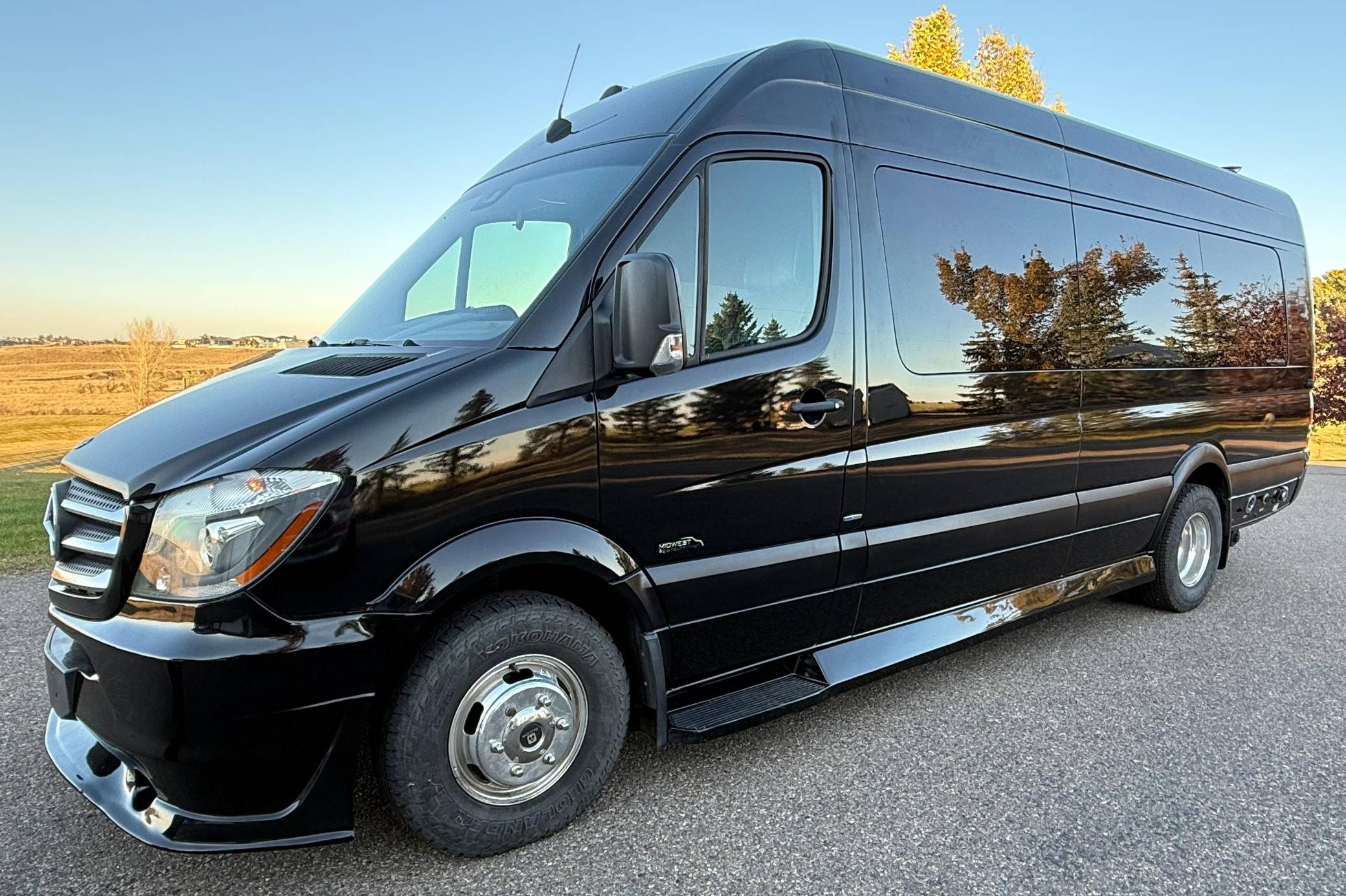 Black Mercedes Sprinter daycruiser van parked outdoors